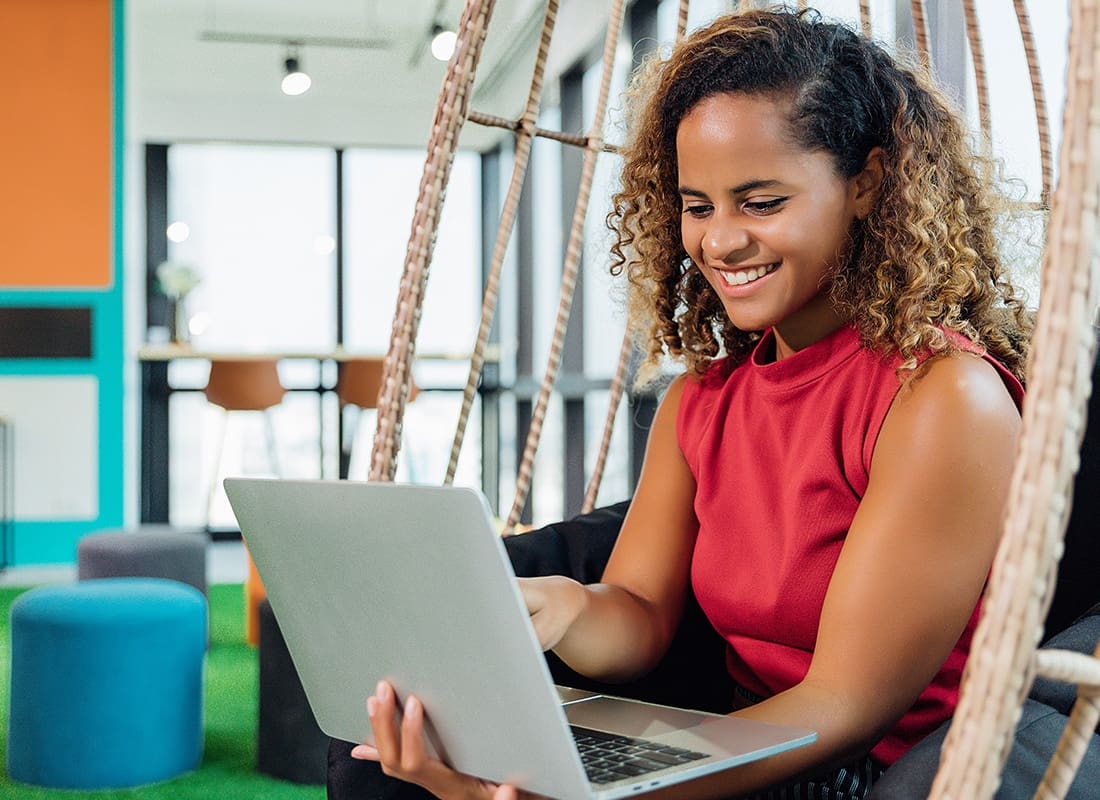 Blog - Cheerful Woman Reading on Her Laptop